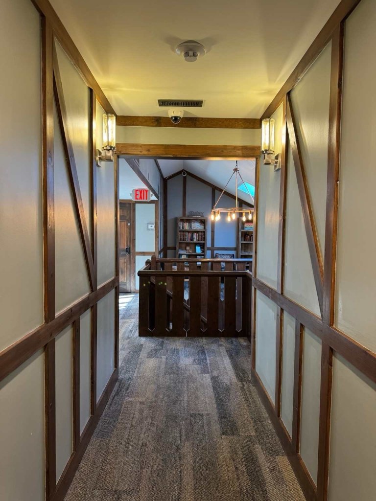 upstairs hallway leading to the stairs and a cozy nook area