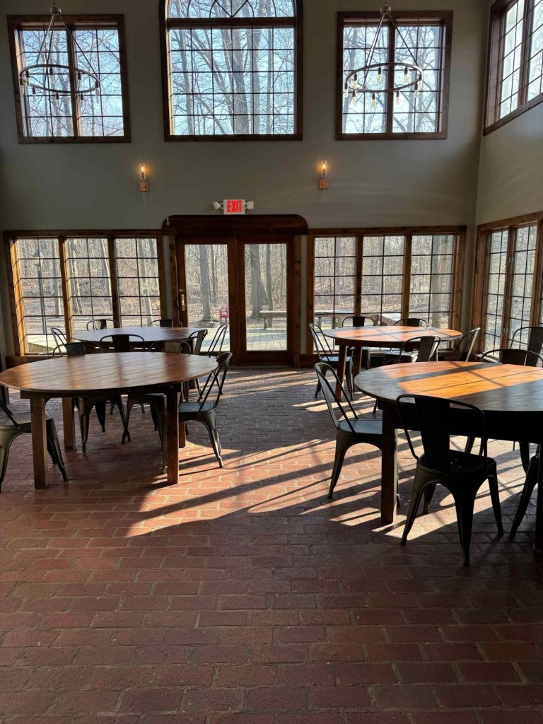 Wheelchair accessible atrium space with round tables and lots of window views