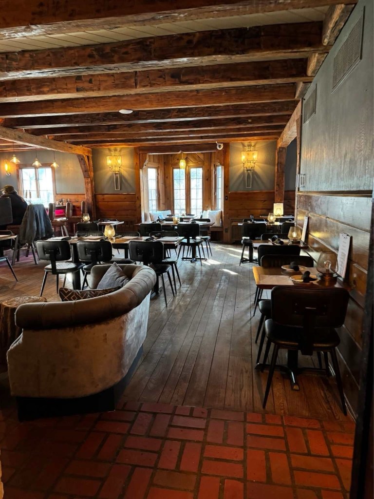 peak inside the hotel restaurant with table and dim lighting 