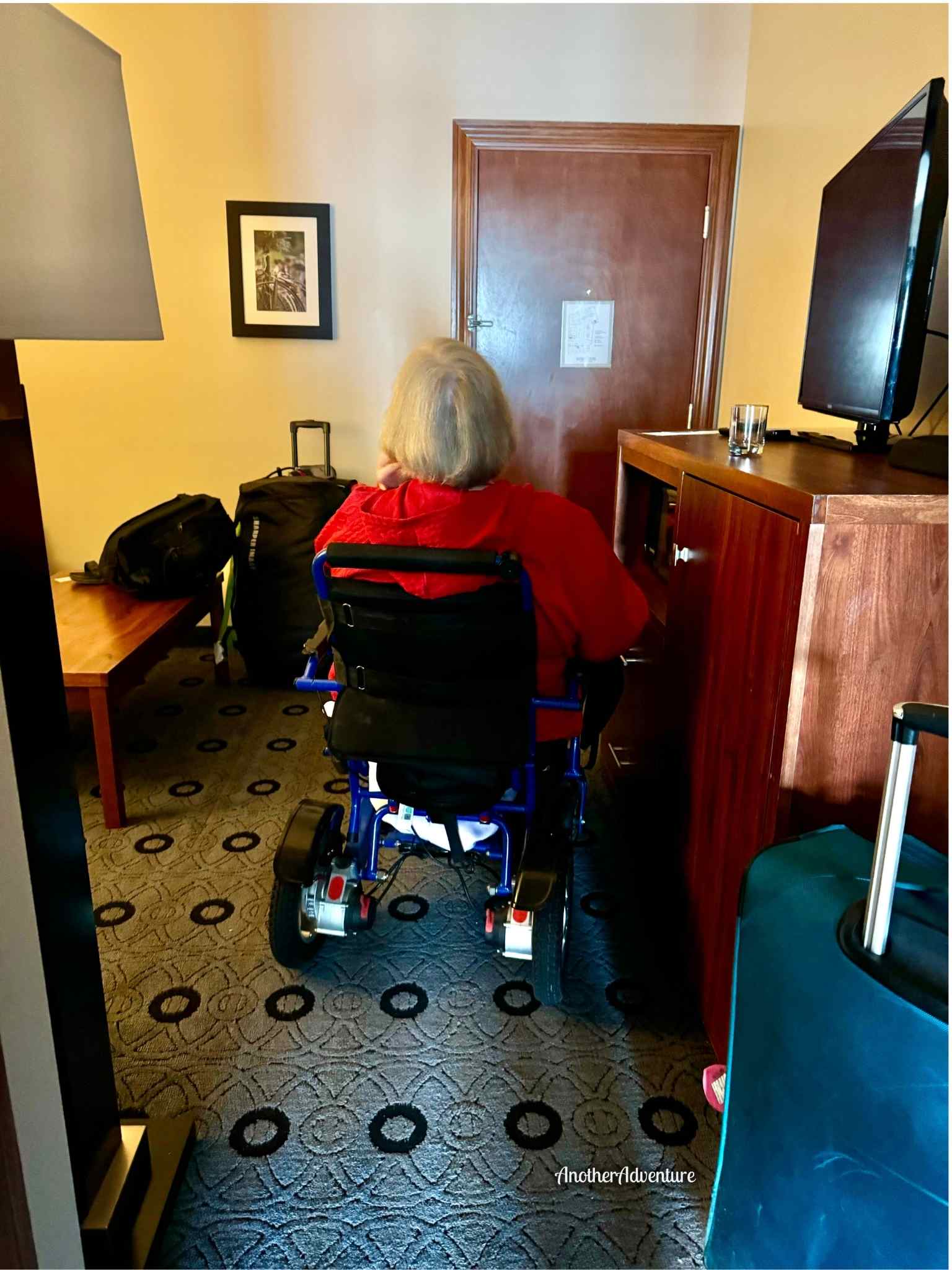 wheelchair navigating in the room in a balcony suite at Bicycle Street Inn and Suites