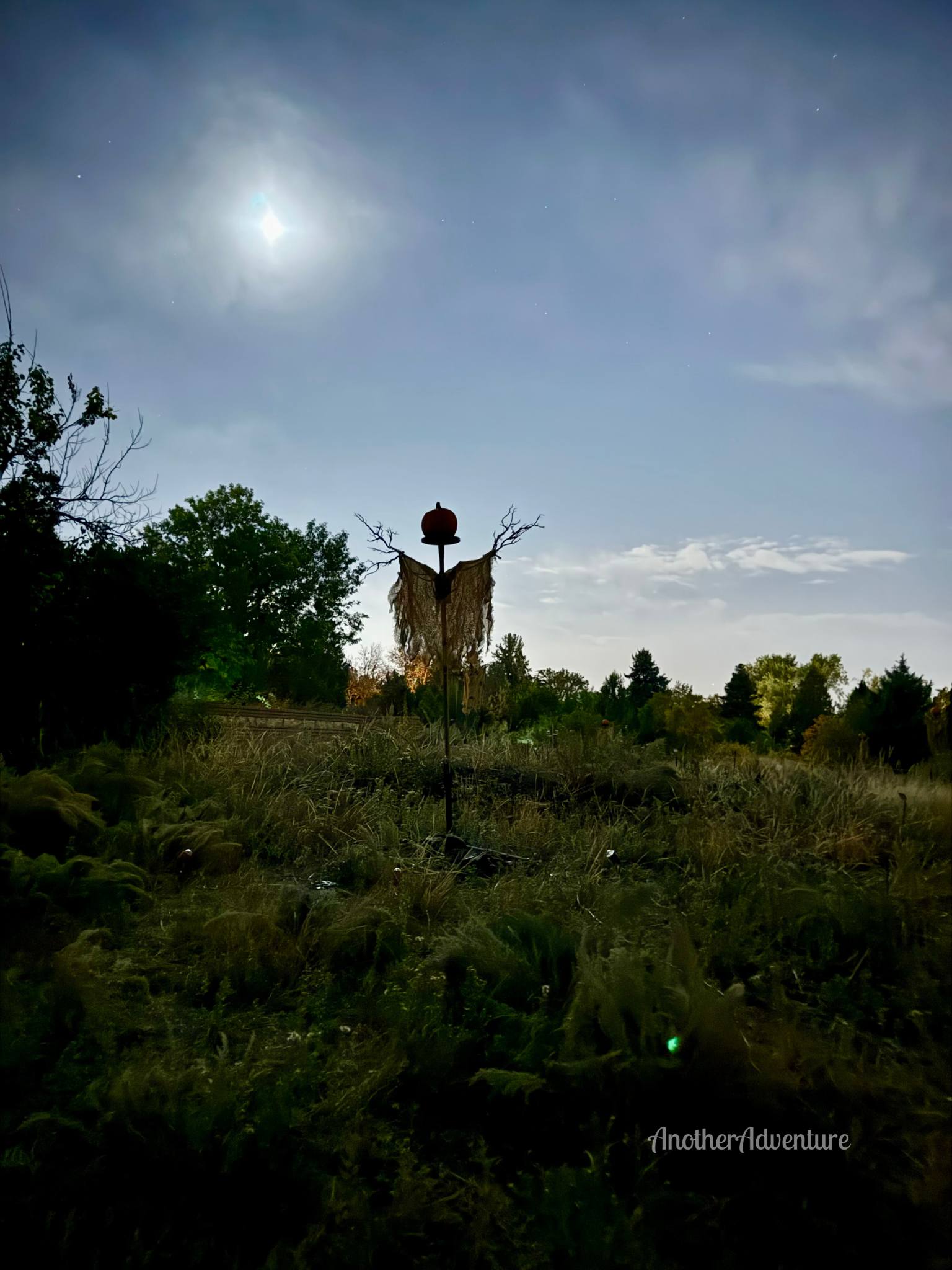 scarecrow with a jack o lantern head