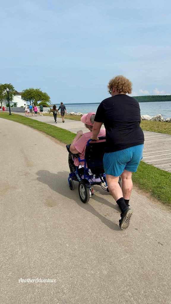 wheelchair being pushed the last leg of the 9 mile loop around mackinac island