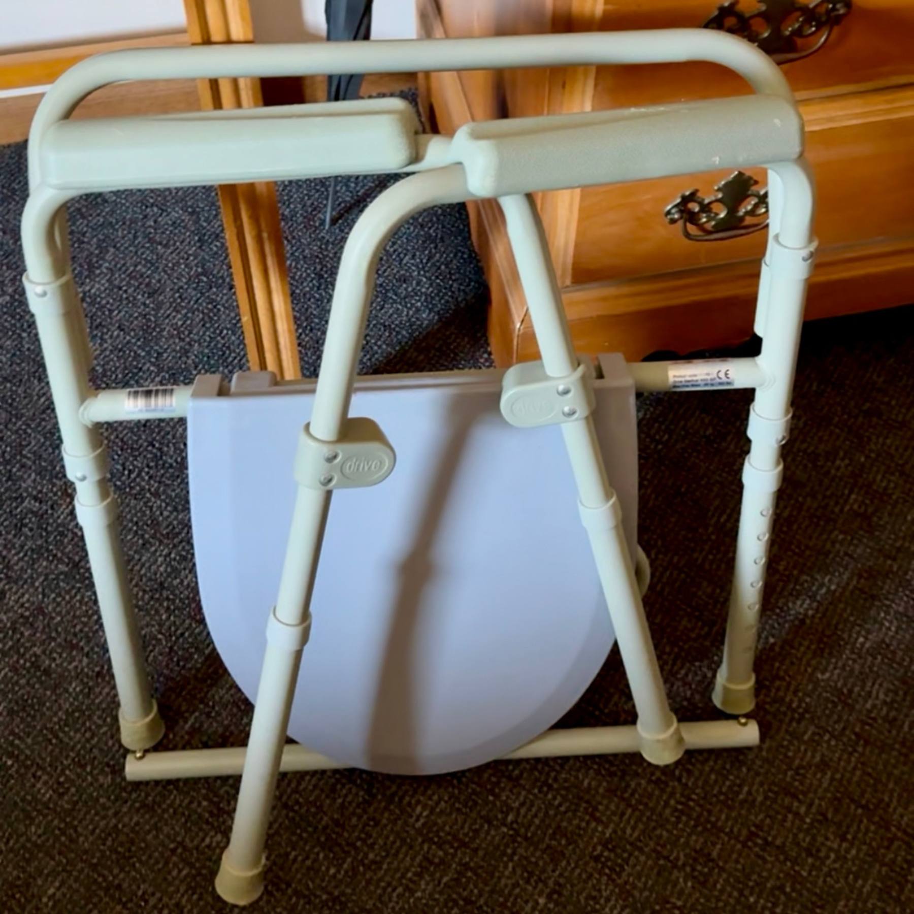 fold up commode shown folded flat for travel portability