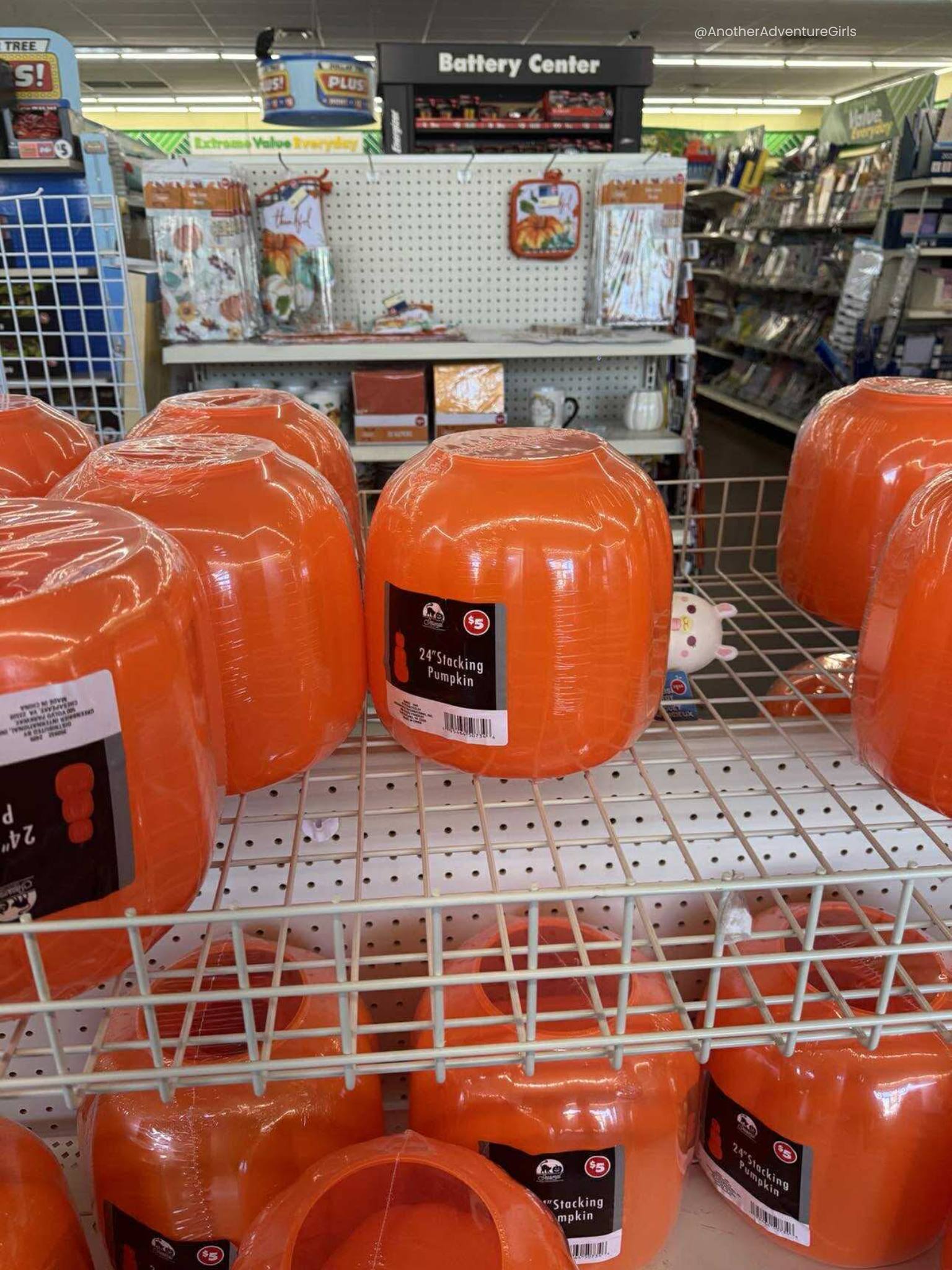 orange stacking pumpkins on a shelf at the Dollar Tree