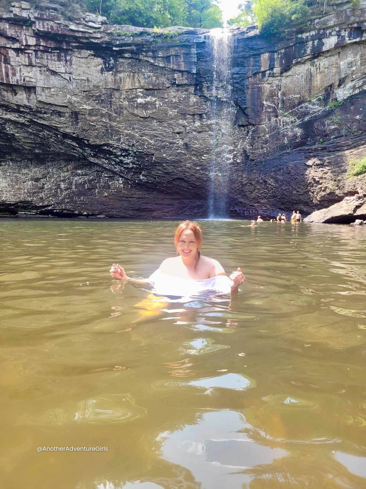 Erin swimming under under the waterfall at Foster Falls