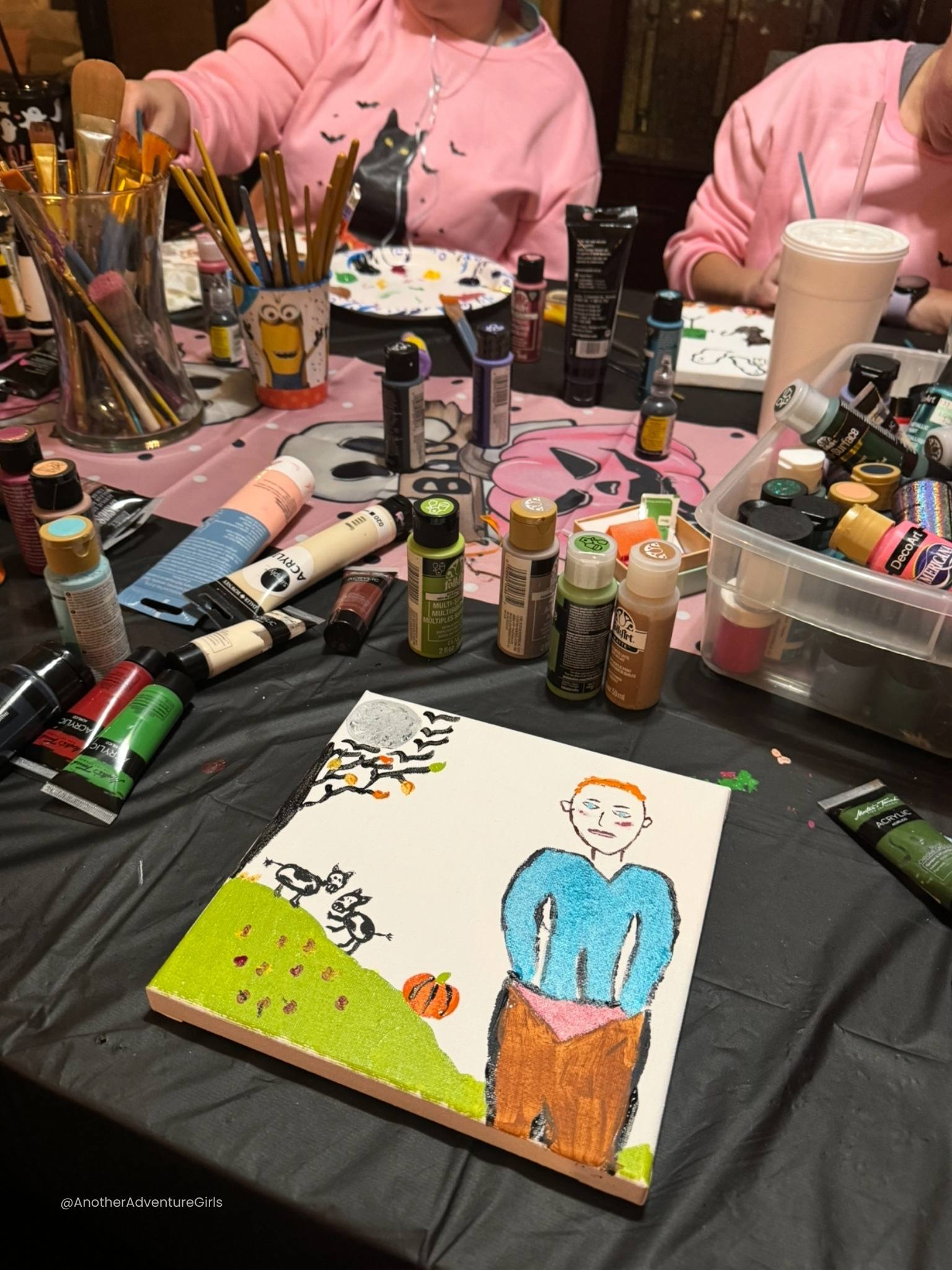 finished painting of a man with orange hair and hands in his pockets with added details such as a tree, green hill on the left and color added to the canvas