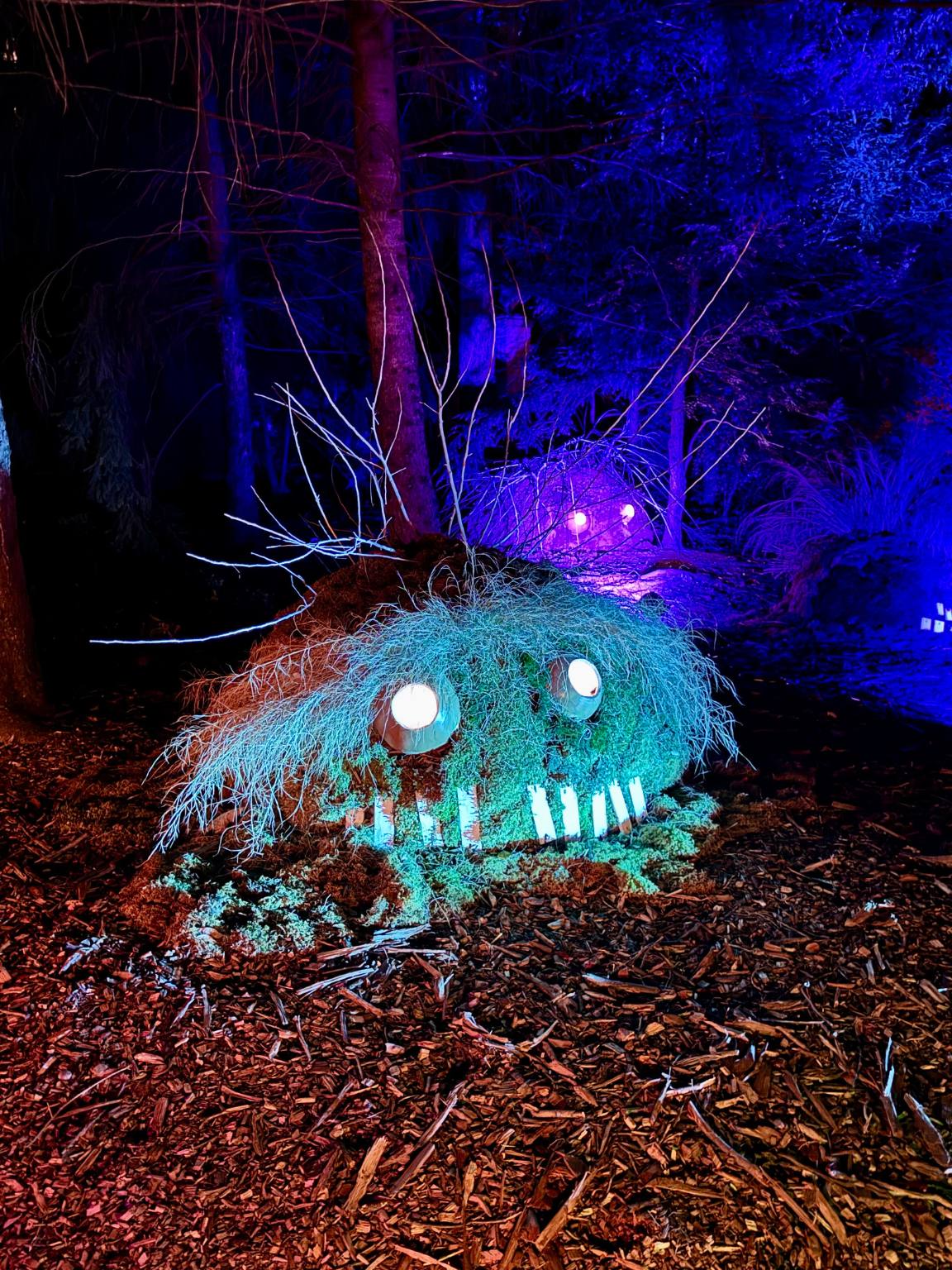 short green blob monster with glowing eyes and crooked teeth