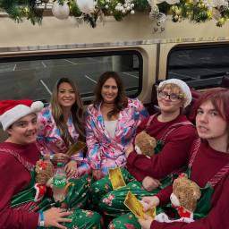 five people sitting in a pod section of the polar express in st louis