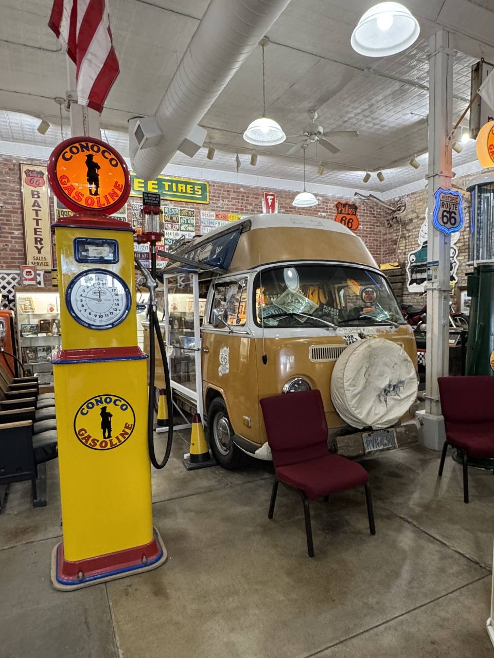 old yellow and red gas pump to the left of Bob Waldmire's historic VW inside the Route 66 museum
