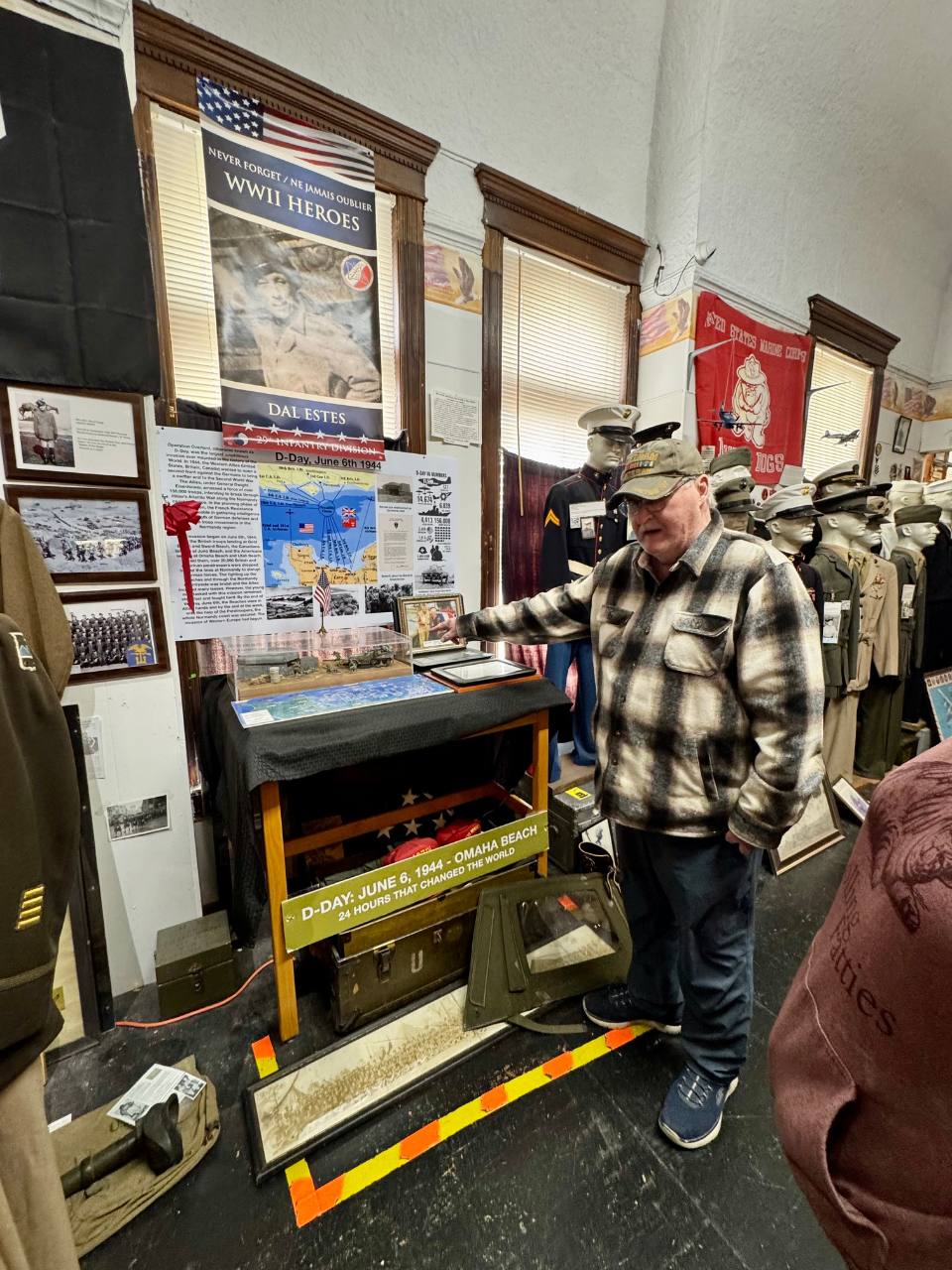 David Estes pointing to information and explaining things at the World War 2 museum