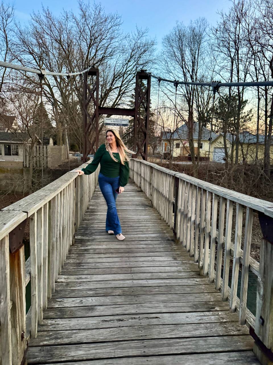 Jodi walking on one of the historic swinging bridges in Pontiac Illinois at sunset