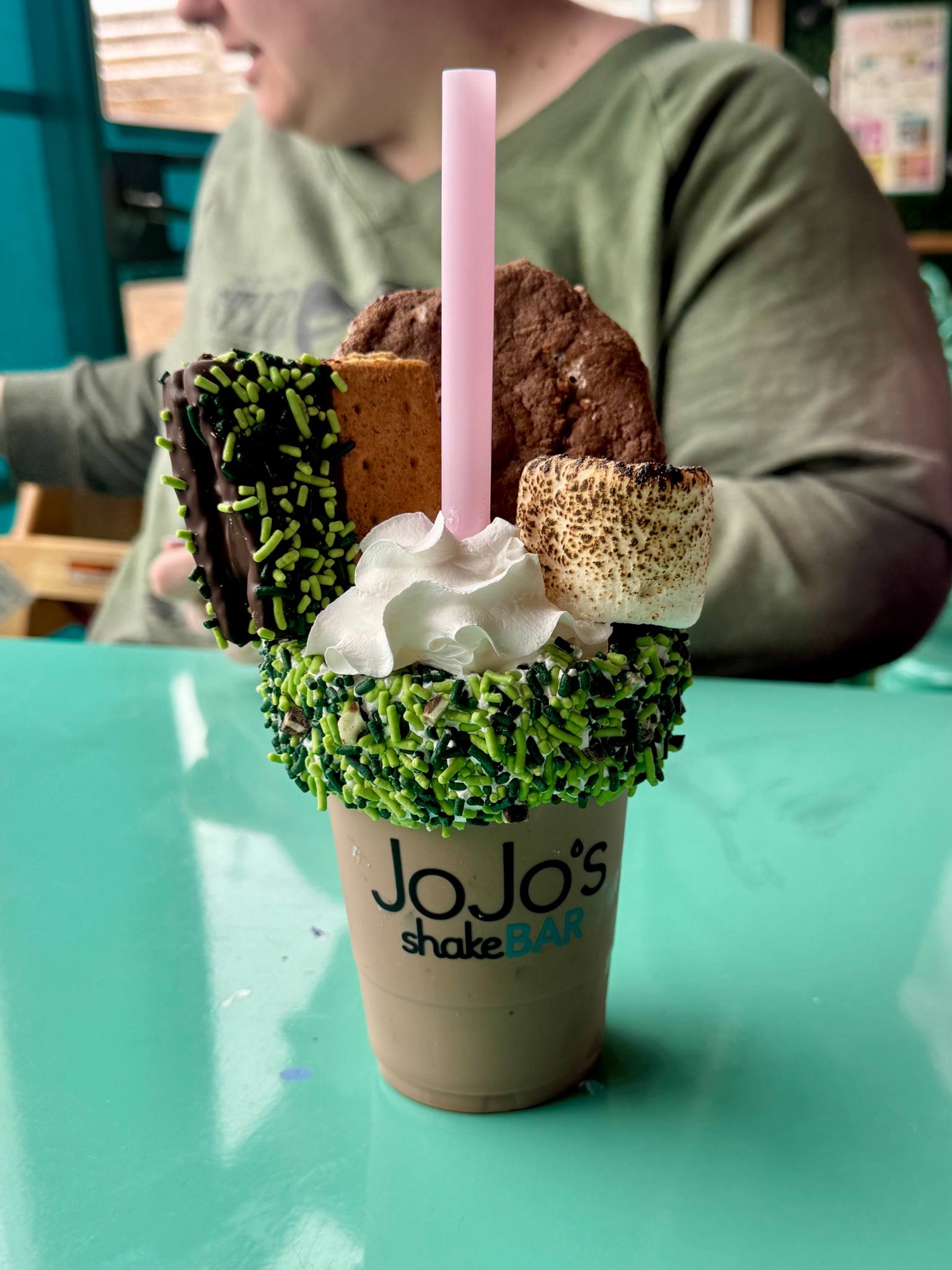 milkshare with green springles, a toasted marchmallow and smore