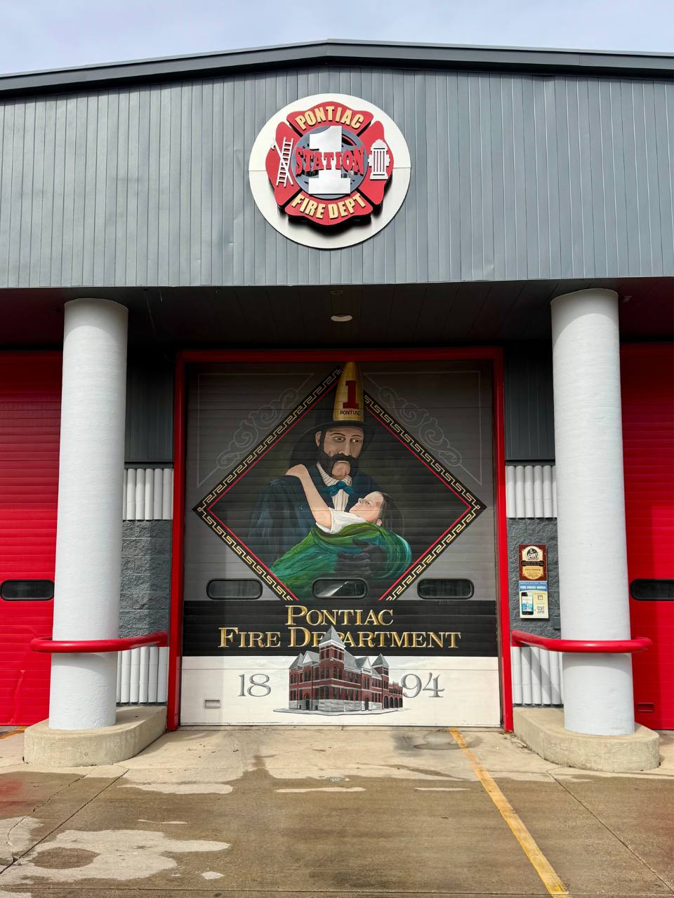 pontiac illinois firestation mural showing a fireman holding vaguely child or adult, male or female body