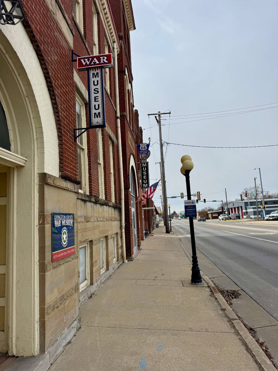 one side of a brick building with showing signs and entrance to the route 66 and WWII museums