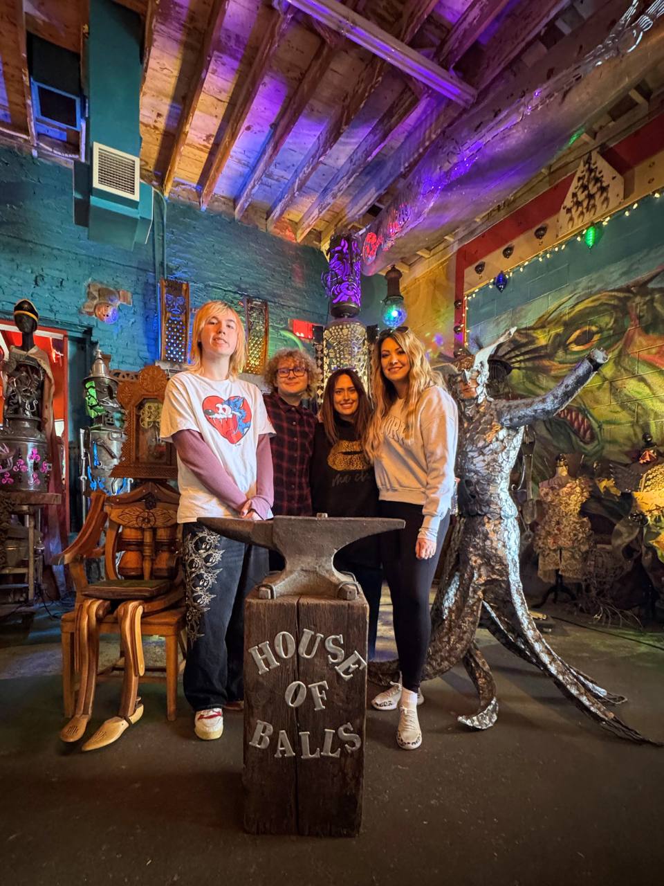 silas, zavier, erin and jodi smiling in a photo op spot at the house of balls in minneapolis