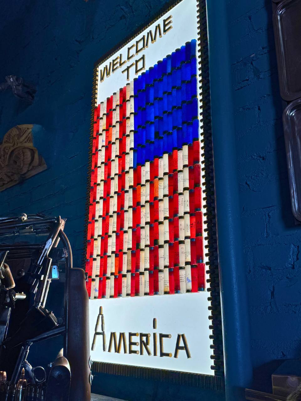 drug vials used to create an american flag with copy that reads this is america worked into the art piece